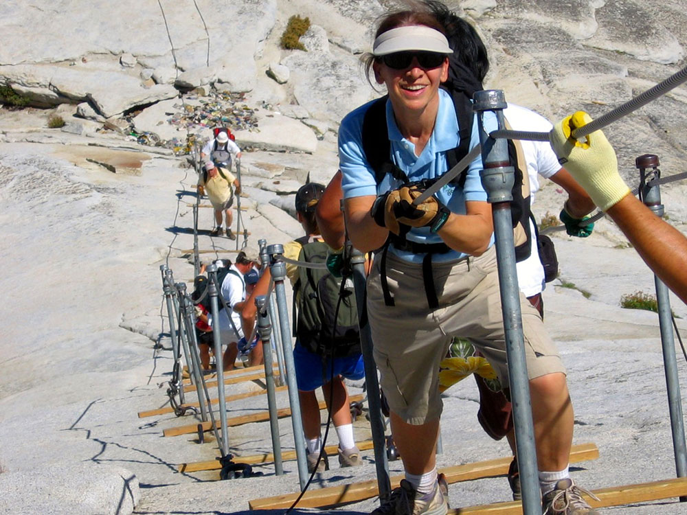 Hikers climbing the Half Dome cables